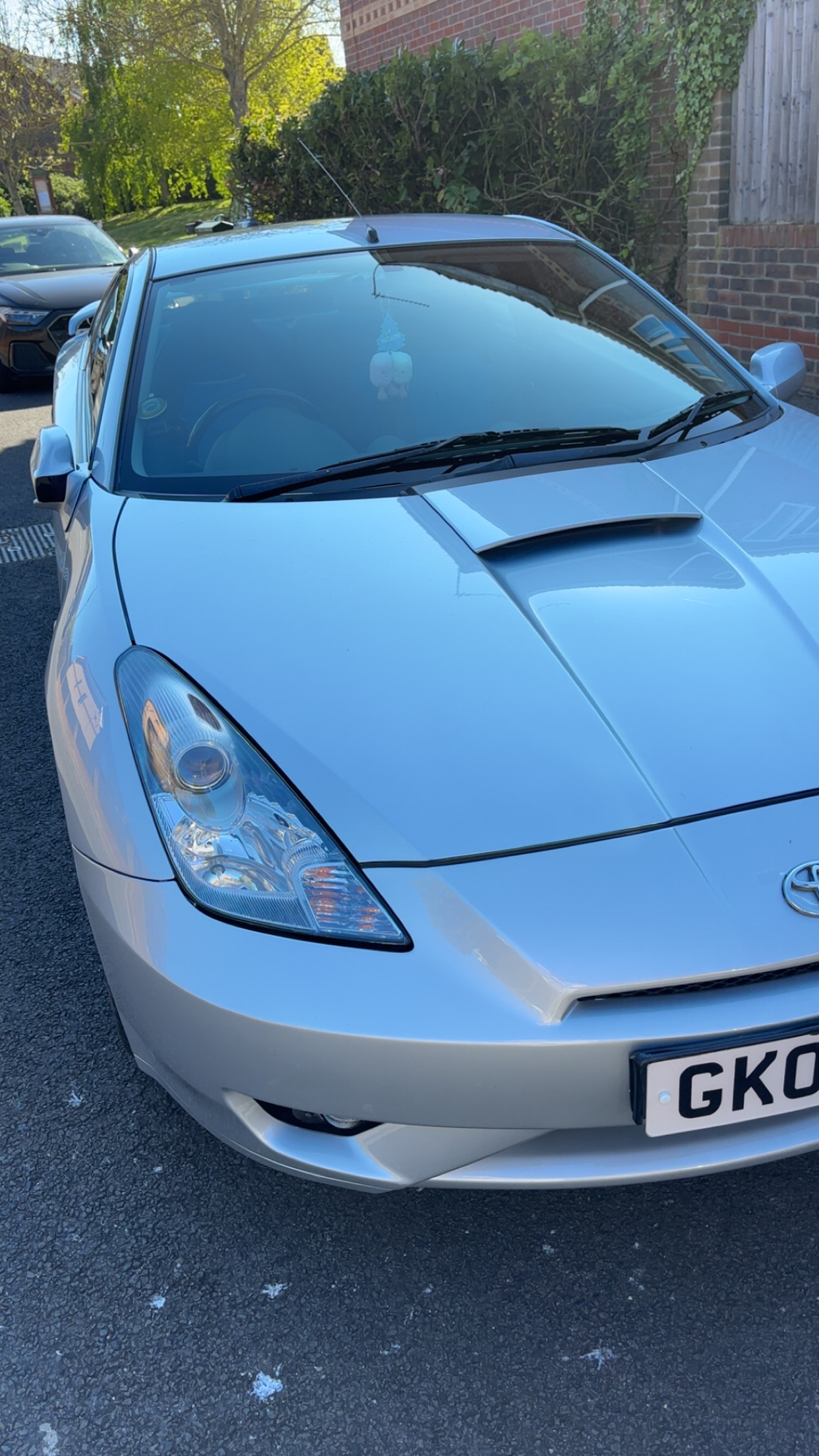 The same silver Toyota Celica after repair, bumper and bonnet gleaming