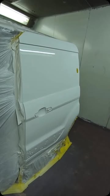 White van door masked in the spray booth