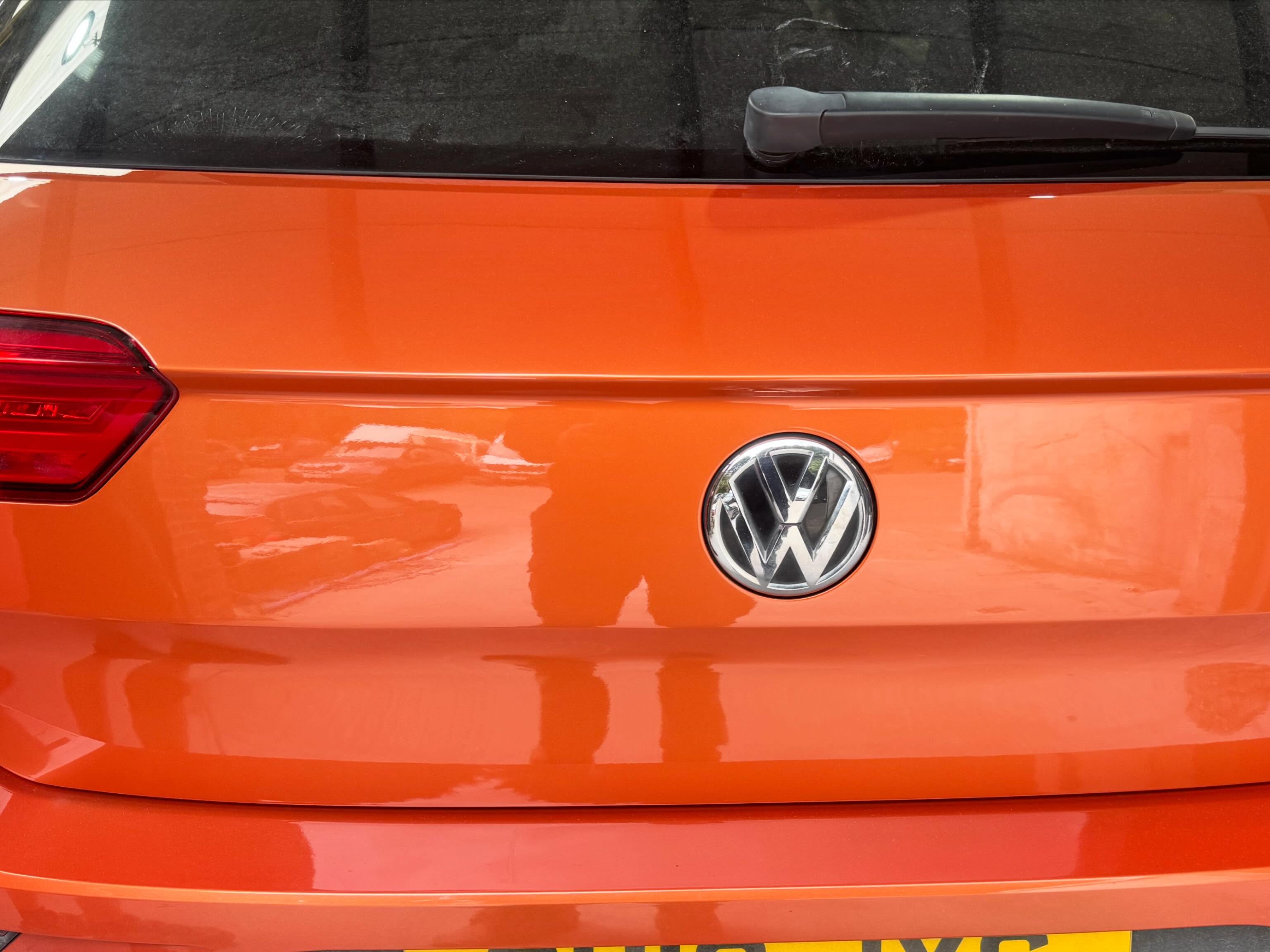 Orange VW T-Roc tailgate with a mirror finish after repair